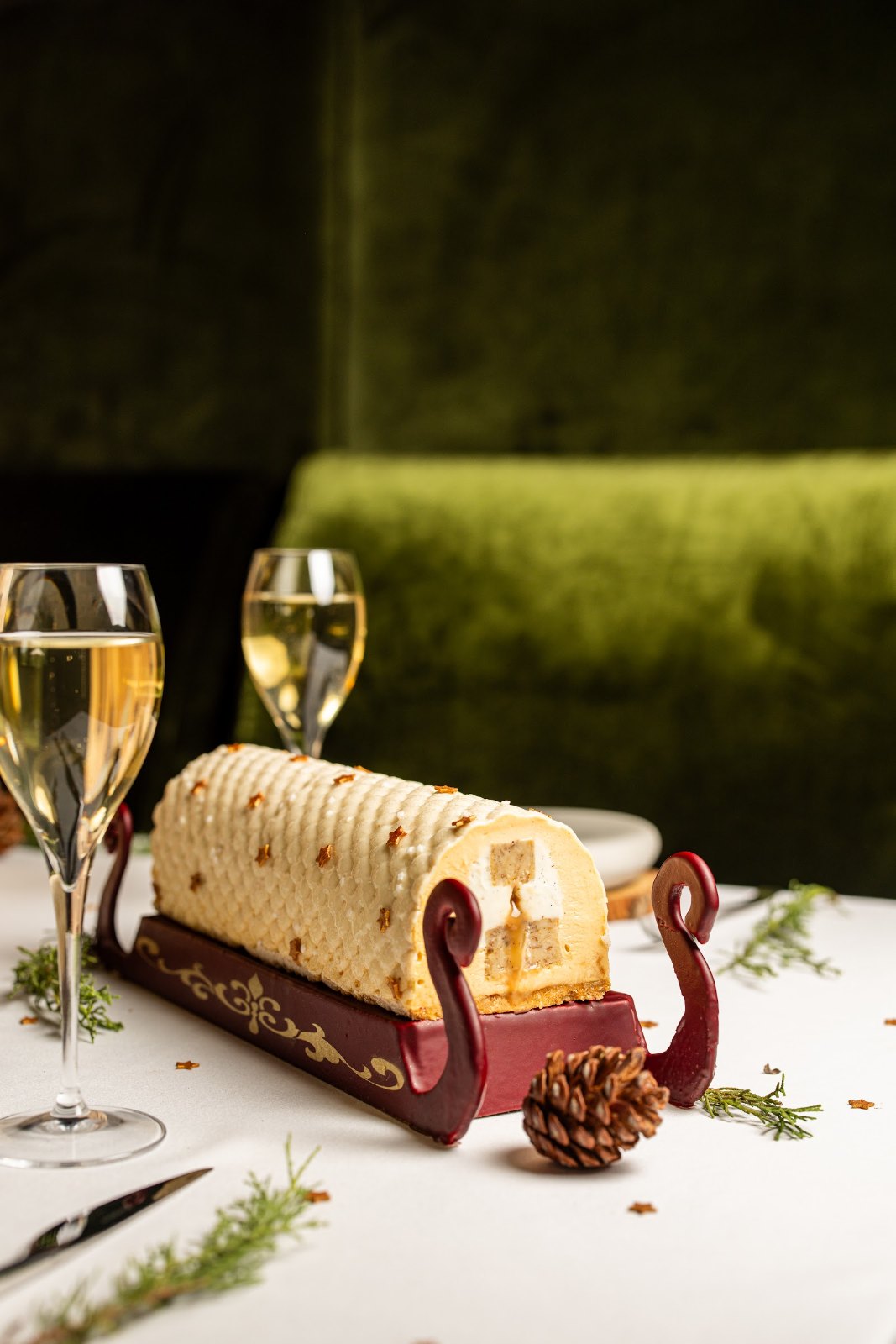 Bûche de Noël sur luge rouge et coupes de champagne, Terre Blanche