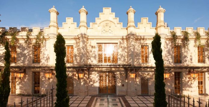 Façade néogothique en pierre blonde des anciens chais Calvet, devenue celle du Mondrian Bordeaux Les Carmes