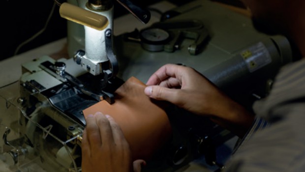 Couture d’une pièce de cuir sur une machine à coudre dans l’atelier Nodie’s à Romans-sur-Isère